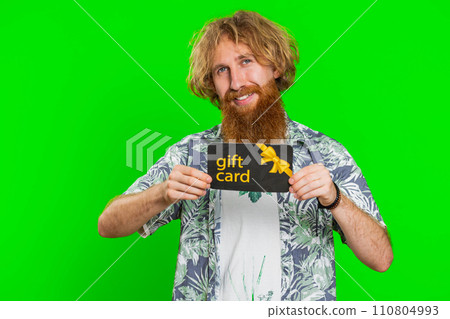 Happy man showing pointing on gift discount certificate voucher coupon for store holidays sale 110804993