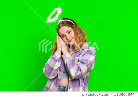 Portrait of smiling shy angelic young woman with angel halo nimb over head, positive love emotions Portrait of smiling shy angelic young woman with angel halo nimb over head, positive love emotions 110805044