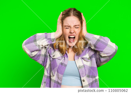 Annoyed irritated young woman covering ears gesturing no avoiding advice ignoring noise loud voices 110805062