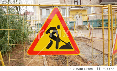 Road works signs on a fence, construction and building industry. Road works signs on a fence, construction and building industry. 110805372