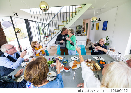 Joyful Gathering: Elderly Friends Enjoying a Meal Together Joyful Gathering: Elderly Friends Enjoying a Meal Together 110806412