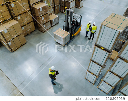 Top view of workers modern warehouse storage of retail shop, large factory workshop space. Employees in modern industrial factory with warehouse. 110806939