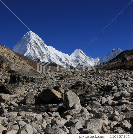 Stony trail of the Everest Base Camp Trek and snow covered Mount Pumori, Nepal. Stony trail of the Everest Base Camp Trek and snow covered Mount Pumori, Nepal. 110807165