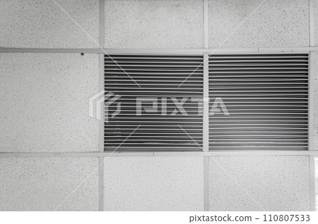 Ceiling mounted cassette type air conditioner and modern lamp light on white ceiling. Duct air conditioner for home, hall or office. 110807533