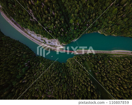 Aerial view of big metal railway bridge across river, in the middle of summer forest. 110807859