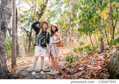 Lovely couple lesbian woman with backpack hiking in nature. Loving LGBT romantic moment in mountains 110807942