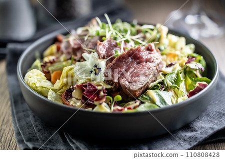 Fillet of beef sirloin with lettuce salad in plate on pub or restaurant 110808428