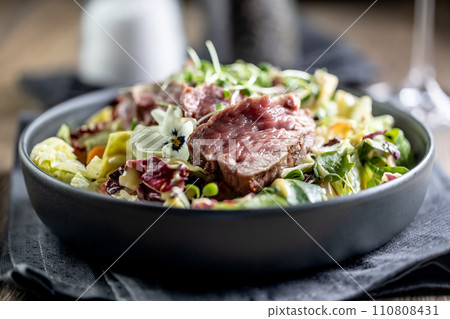 Fillet of beef sirloin with lettuce salad in plate on pub or restaurant 110808431