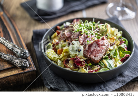 Fillet of beef sirloin with lettuce salad in plate on pub or restaurant 110808433