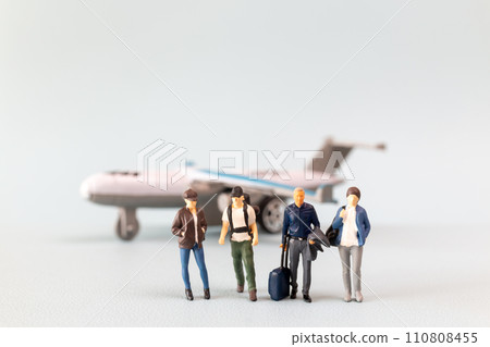 Miniature people, travelers embarks on a delightful vacation, gleefully boarding a tiny airplane 110808455