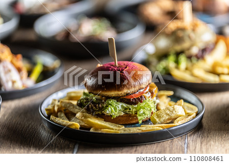 Beef burger with fries and draft beer on a pub or restaurant plate 110808461