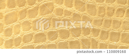 Light yellow background from soft upholstery textile material, closeup. Golden fabric with pattern Light yellow background from soft upholstery textile material, closeup. Golden fabric with pattern 110809168