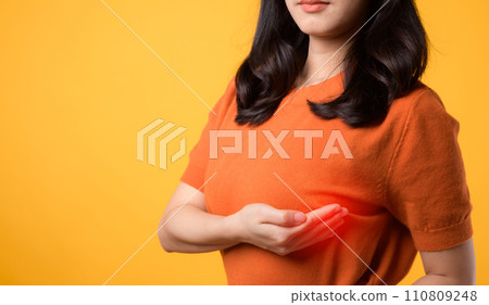 Prioritize breast health on World Health Day, witnessing a woman's breast cancer check on vibrant yellow background. Prioritize breast health on World Health Day, witnessing a woman's breast cancer check on vibrant yellow background. 110809248