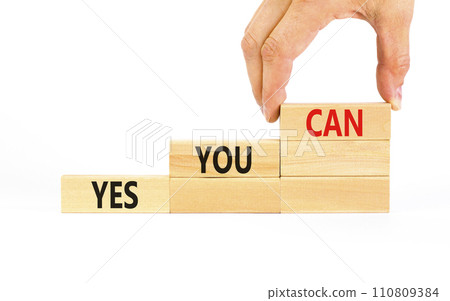 Motivational and Yes you can symbol. Concept words Yes you can on beautiful wooden blocks. Beautiful white background. Businessman hand. Business motivational and Yes you can concept. Copy space. 110809384