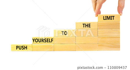 Push the limit symbol. Concept words Push yourself to the limit on wooden blocks. Beautiful white table white background. Businessman hand. Business push the limit concept. Copy space. 110809437