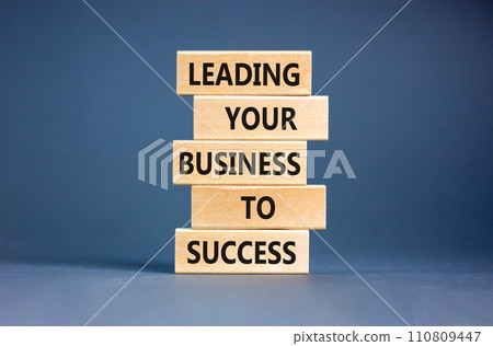 Leading your business to success symbol. Concept words Leading your business to success on wooden blocks. Beautiful grey table grey background. Leading your business to success concept. Copy space. Leading your business to success symbol. Concept words Leading your business to success on wooden blocks. Beautiful grey table grey background. Leading your business to success concept. Copy space. 110809447