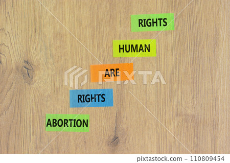 Abortion rights symbol. Concept words Abortion rights are human rights on colored paper. Beautiful wooden table wooden background. Business medical abortion rights concept. Copy space. 110809454