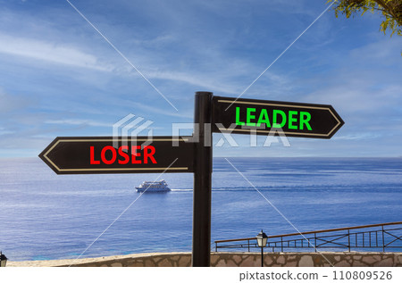 Leader or loser symbol. Concept word Leader or Loser on beautiful signpost with two arrows. Beautiful blue sea sky with clouds background. Business and leader or loser concept. Copy space. Leader or loser symbol. Concept word Leader or Loser on beautiful signpost with two arrows. Beautiful blue sea sky with clouds background. Business and leader or loser concept. Copy space. 110809526