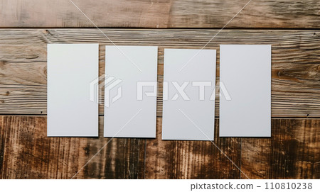 four white cards lined up on the table 110810238