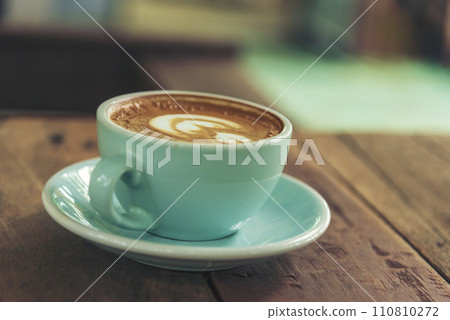 Latte art coffee cup with milk on wooden table. Espresso shot make latte art hot coffee cup. Cappuccino with milk in italian coffee shop cafe. Brown hot caffeine beverage in cafeteria with copy space 110810272