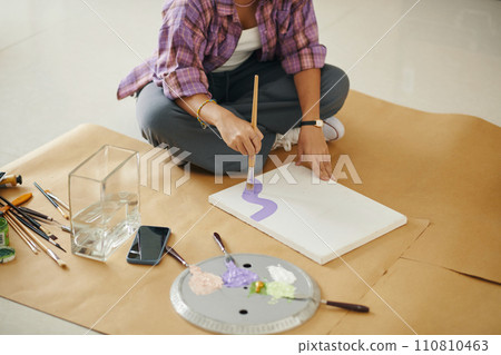Girl painting abstract picture to decorate her bedroom Girl painting abstract picture to decorate her bedroom 110810463