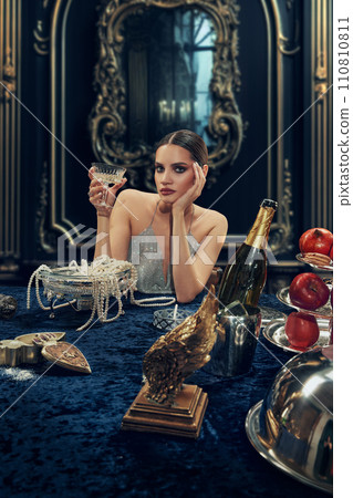 Portrait of elegant beautiful young woman in luxurious sparkling dress raising glass with champagne. Wealthy lifestyle. Portrait of elegant beautiful young woman in luxurious sparkling dress raising glass with champagne. Wealthy lifestyle. 110810811