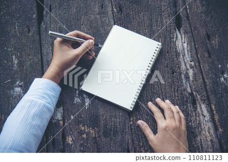 Businesswoman hands note document. Hands writing on empty notebook. Woman planning working on eco sustainable outdoors. Female hand holding pencil write on blank sketchbook. Mock-up Concept 110811123