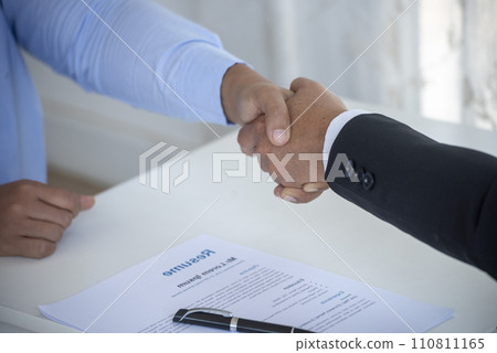 Team Business Partners shaking hands together to Greeting Start up new project. Shakehand Teamwork Partnership at office desk. Businessman partners handshake together.  Business concept 110811165