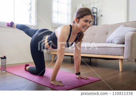 Young asian healthy happy woman workout at home, exercise, doing yoga, home fitness concept 110811338
