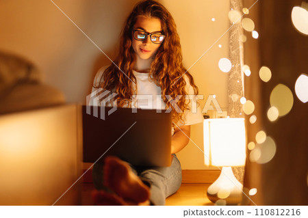 Woman working online on laptop computer at home. Business, blogging, freelance, education concept. 110812216