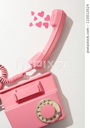 Phone with hearts on a light background. 110812624