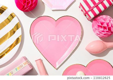 A pink heart-shaped plate on a light background. A pink heart-shaped plate on a light background. 110812625