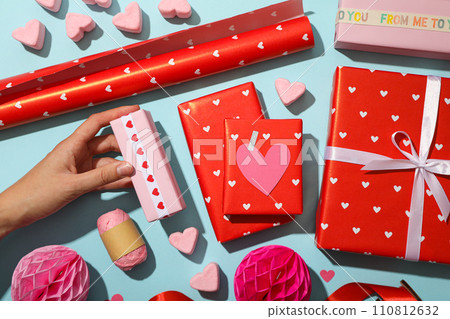 Red gifts on a blue background, concept for Valentine's Day. Red gifts on a blue background, concept for Valentine's Day. 110812632