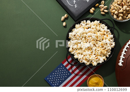 Blackboard with rugby strategy, bowl of popcorn and flag 110812699