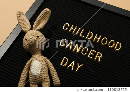 A black board with the inscription Childhood Cancer Day and with a rabbit 110812755