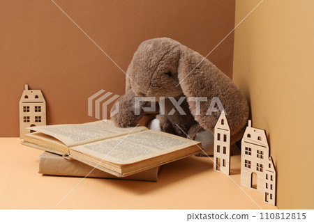 A children's book with toys on a beige background. A children's book with toys on a beige background. 110812815