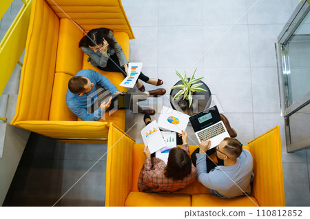 Successful team. Group of young businessmen working and communicating together in creative office. 110812852