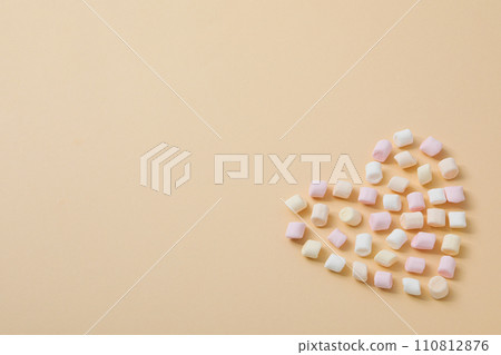 A heart made of sweet candies on a light background. A heart made of sweet candies on a light background. 110812876