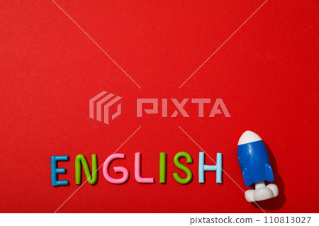 The word English with a rocket next to it, on a red background. The word English with a rocket next to it, on a red background. 110813027