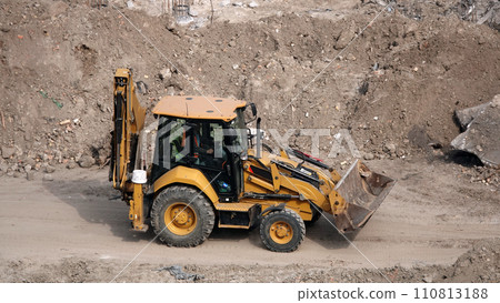Kiev, Ukraine March 13, 2019: Tractors and excavators work on the construction of the foundation zero cycle Kiev, Ukraine March 13, 2019: Tractors and excavators work on the construction of the foundation zero cycle 110813188