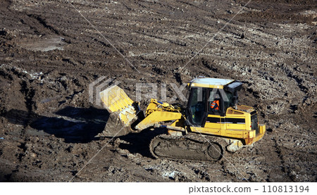 Kiev, Ukraine March 13, 2019: Tractors and excavators work on the construction of the foundation zero cycle Kiev, Ukraine March 13, 2019: Tractors and excavators work on the construction of the foundation zero cycle 110813194