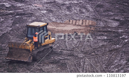 Kiev, Ukraine March 13, 2019: Tractors and excavators work on the construction of the foundation zero cycle Kiev, Ukraine March 13, 2019: Tractors and excavators work on the construction of the foundation zero cycle 110813197