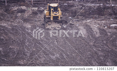 Kiev, Ukraine March 13, 2019: Tractors and excavators work on the construction of the foundation zero cycle Kiev, Ukraine March 13, 2019: Tractors and excavators work on the construction of the foundation zero cycle 110813207