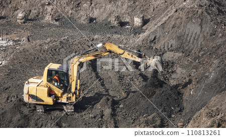 Kiev, Ukraine March 13, 2019: Tractors and excavators work on the construction of the foundation zero cycle Kiev, Ukraine March 13, 2019: Tractors and excavators work on the construction of the foundation zero cycle 110813261