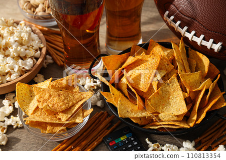 Beer with snacks and a rugby ball 110813354