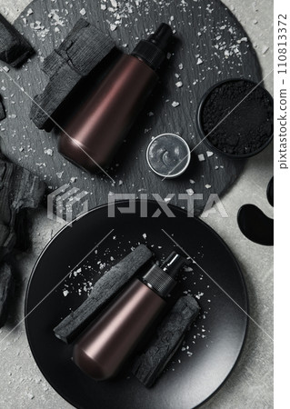 Ecological cosmetics with coal, on a light background. Ecological cosmetics with coal, on a light background. 110813372