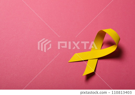 Yellow paper ribbon on a pink background 110813403