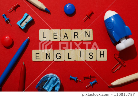 Concept of English lessons, flat lay, on red background. 110813787