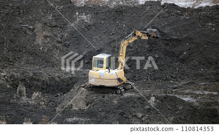 Kiev, Ukraine, October 17, 2018: Workers in the mud of a construction site at the stage of excavation; construction of a supermarket AUCHAN Kiev, Ukraine, October 17, 2018: Workers in the mud of a construction site at the stage of excavation; construction of a supermarket AUCHAN 110814353