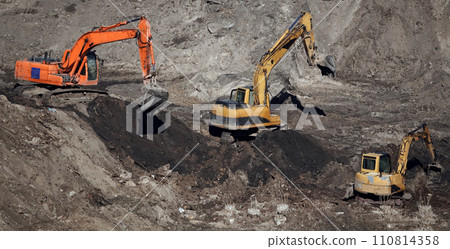 Kiev, Ukraine March 13, 2019: Tractors and excavators work on the construction of the foundation zero cycle Kiev, Ukraine March 13, 2019: Tractors and excavators work on the construction of the foundation zero cycle 110814358